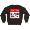 Black sweatshirt reading "Caution, Stand Back" in red and black used to keep people away