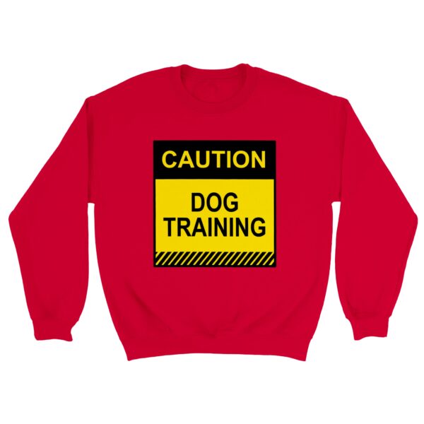 Red sweatshirt reading "Cautions: Dog Training" in yellow and black letters worn during dog training