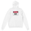 Back of white hoodie reading "Dog Training, Keep Away" in red, white and black letters worn during dog training