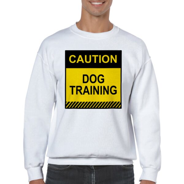 Sweatshirt reading "Cautions: Dog Training" worn during dog training