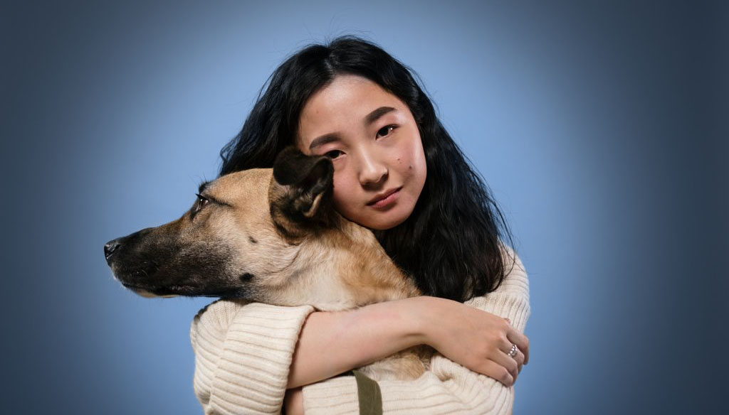 Woman hugging dog fondly